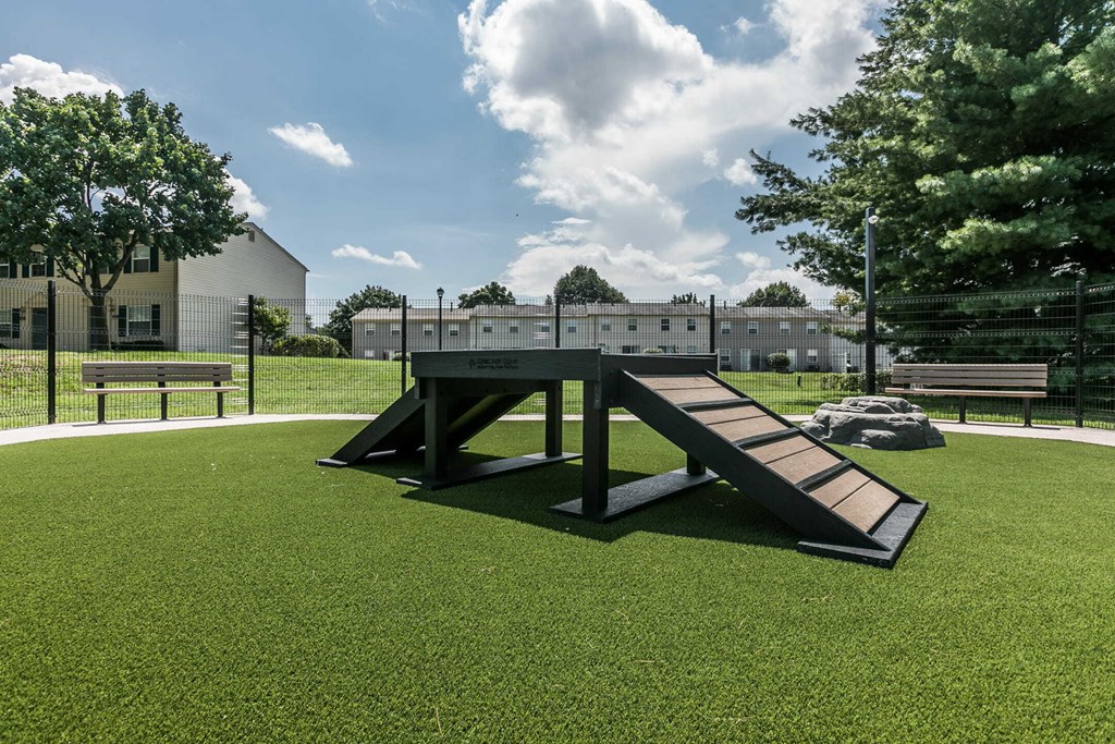 a picnic table in the middle of a grass field