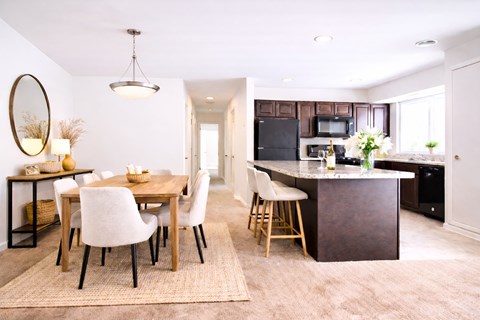 A kitchen with a black refrigerator and black appliances.