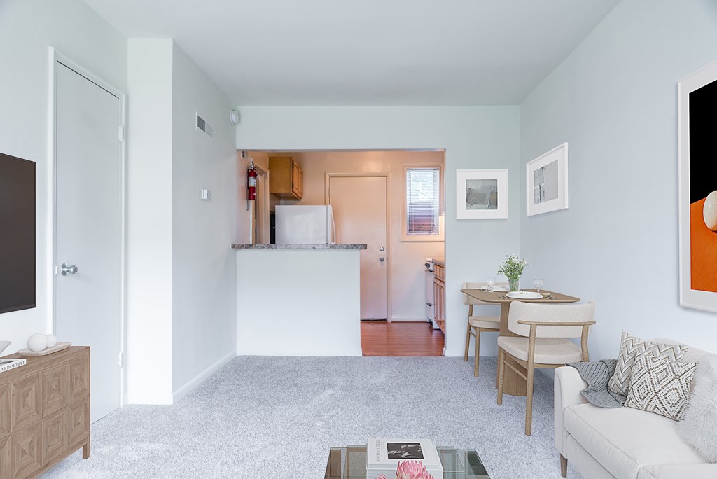 A living room with a couch, coffee table, and a television.