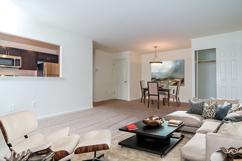 A living room with a white couch and a coffee table.