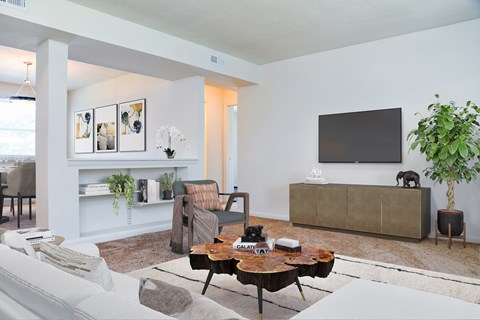 A living room with a grey couch and a brown coffee table.