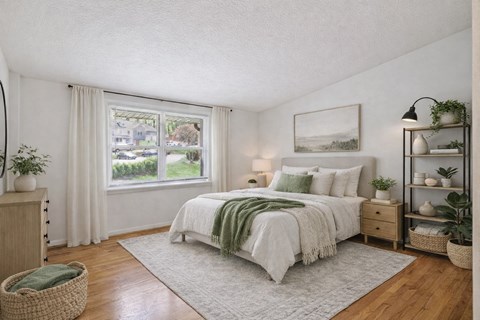 A bedroom with a large bed and a flat screen TV.