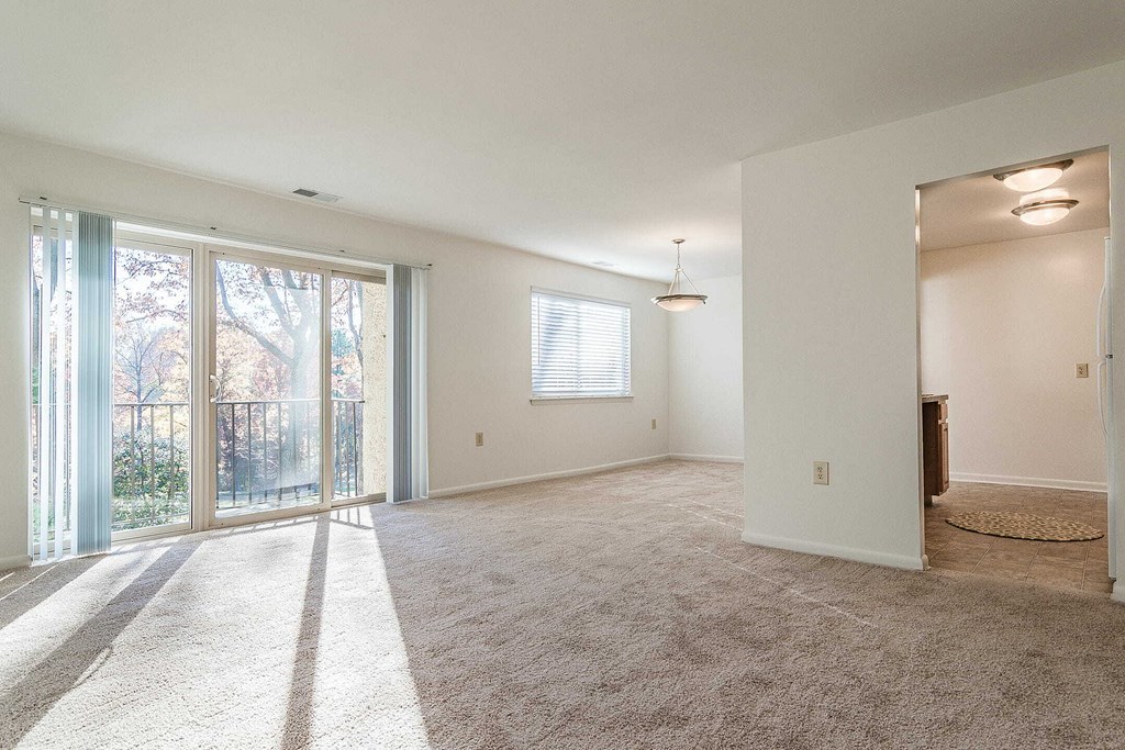 an empty living room with a fireplace and a window