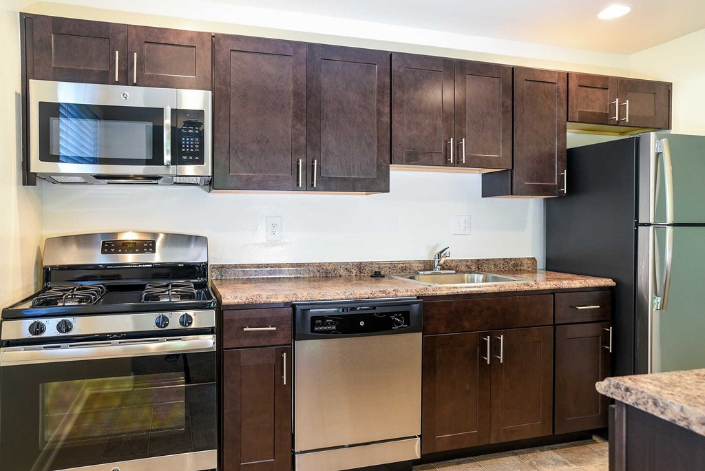 a kitchen with a counter top and a refrigerator
