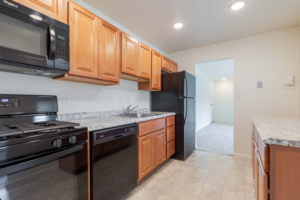 an empty living room with a sliding glass door to a patio