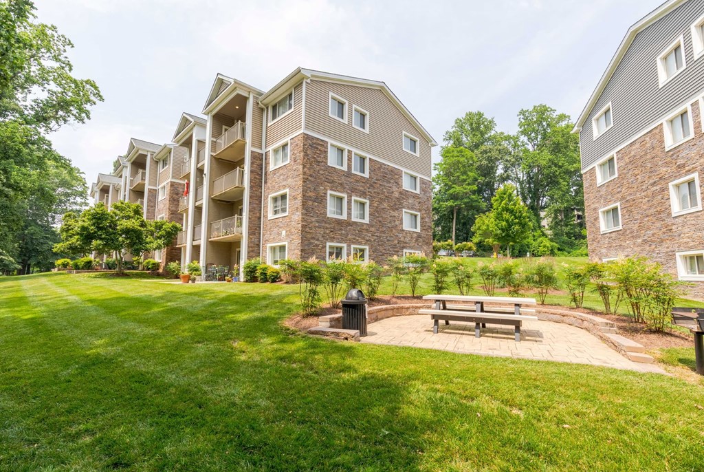two chairs and a picnic table in a park