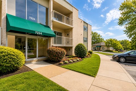 A building with the number 7224 on it has a green awning.