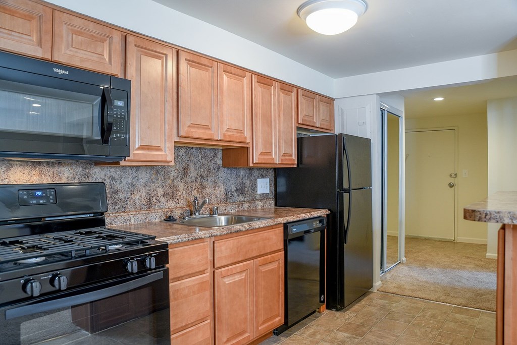 an empty living room with mirrored closet doors