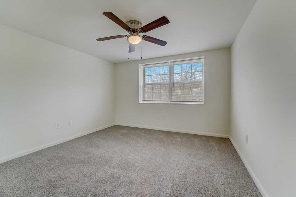 a kitchen with black appliances and wooden cabinets