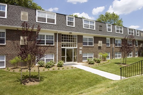 A brick building with a black fence in front.