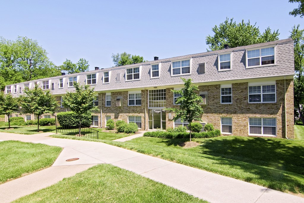 A building with a brown roof and a white fence.