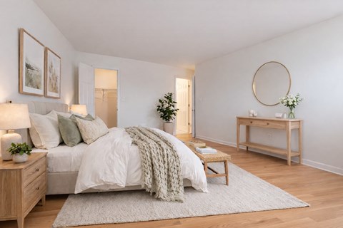 A bedroom with a bed, a nightstand, a dresser, and a painting on the wall.