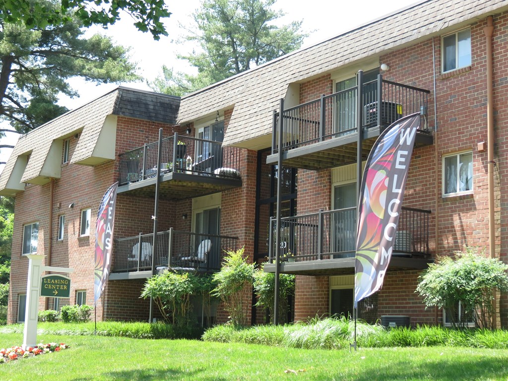 A building with a balcony and a sign that says "Welcome".