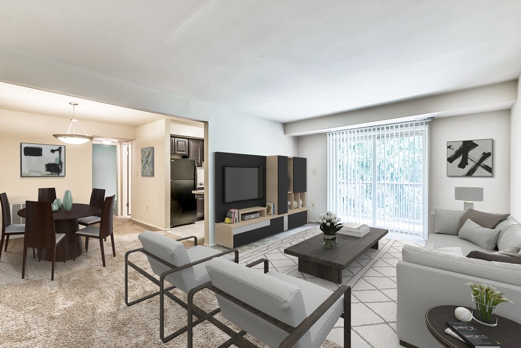 A modern living room with a television, a couch, a chair, a dining table, and a coffee table.