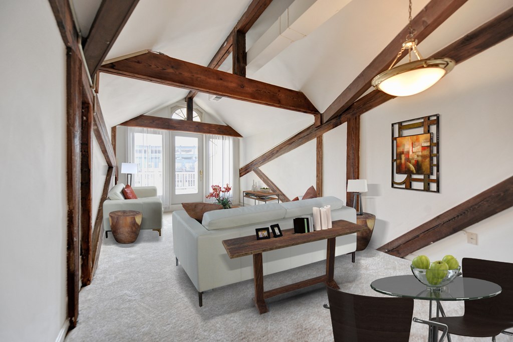 A living room with a couch, chairs, and a coffee table.