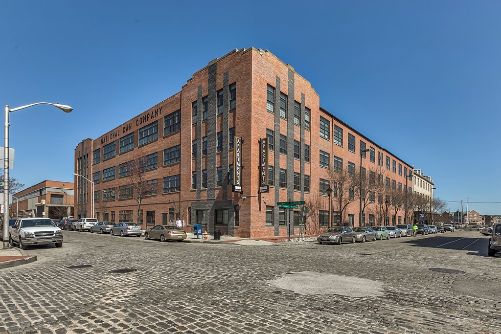 A large red brick building with the words "Hillman Car Company" on the side.