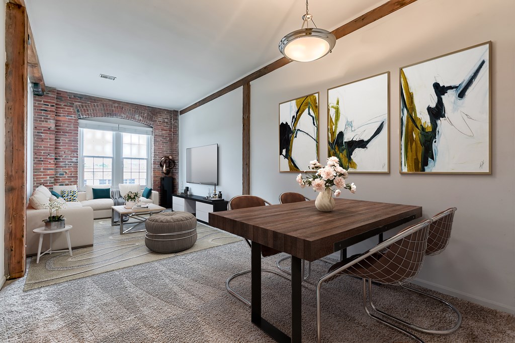 A dining room with a wooden table and chairs.