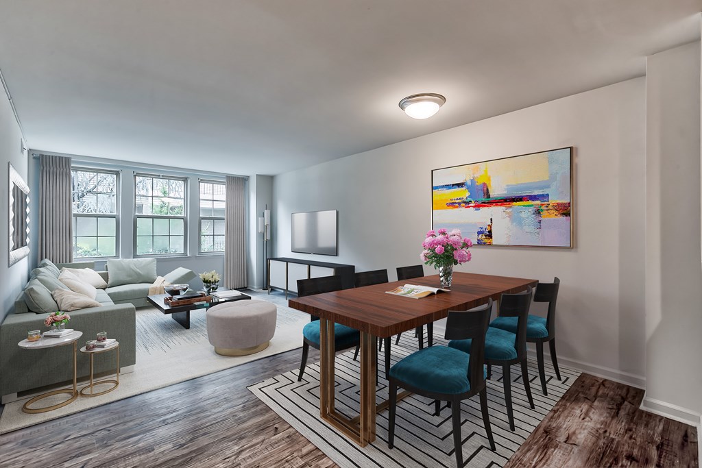 A dining room with a wooden table and chairs.