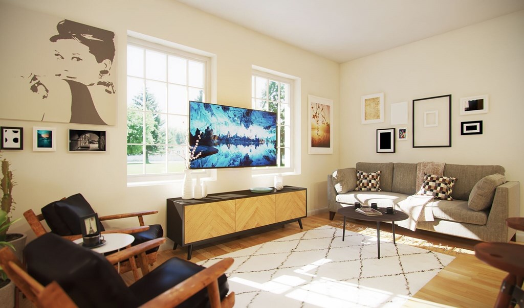 A living room with a couch, chairs, and a television.