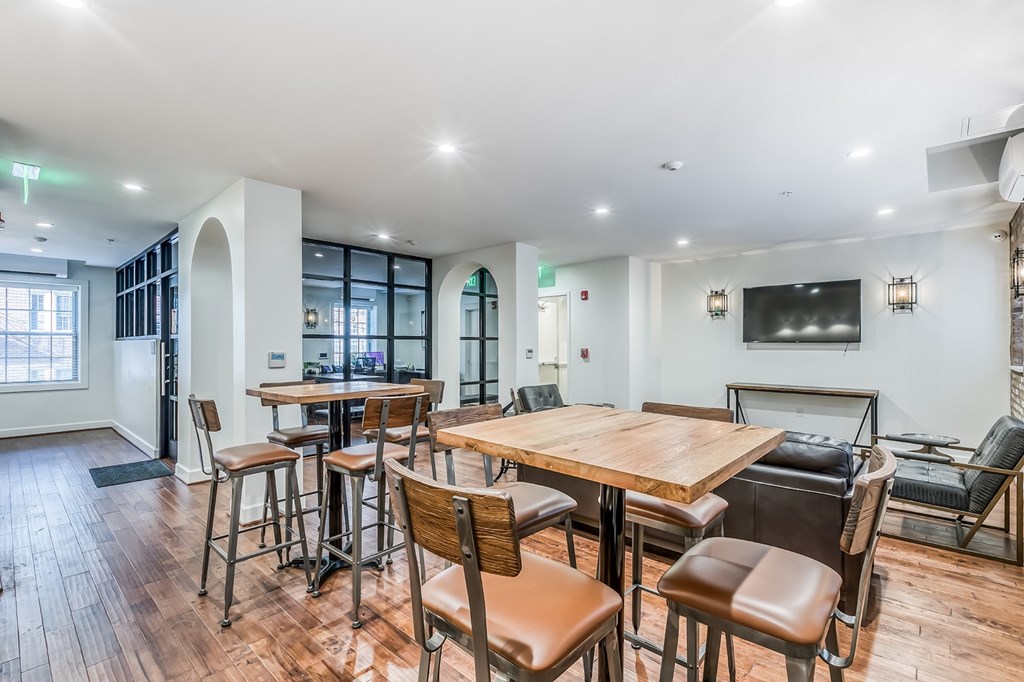 A dining room with a wooden table and chairs.