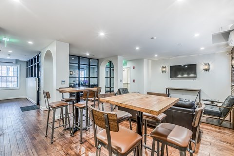 A dining room with a wooden table and chairs.