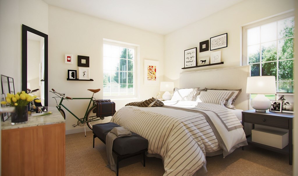 A bedroom with a bed, nightstand, and a bicycle.