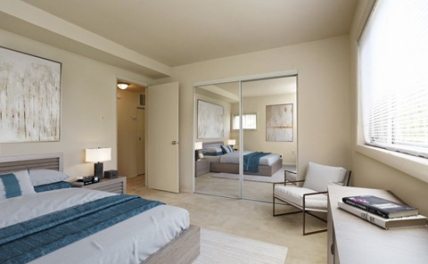 A bedroom with a large bed and a mirrored closet door.