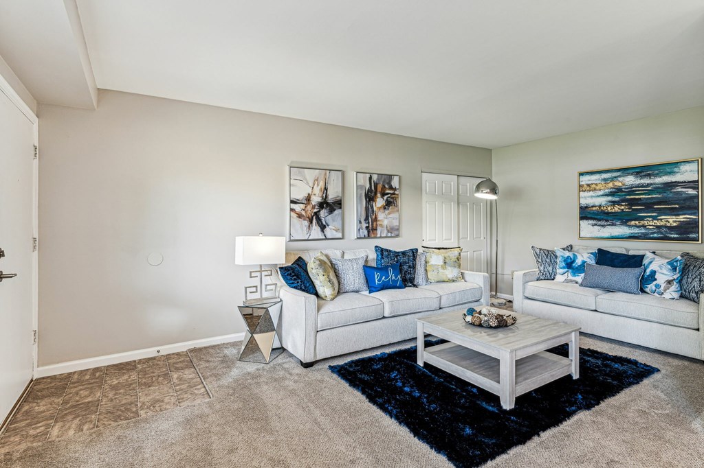 A living room with a white couch and a coffee table.