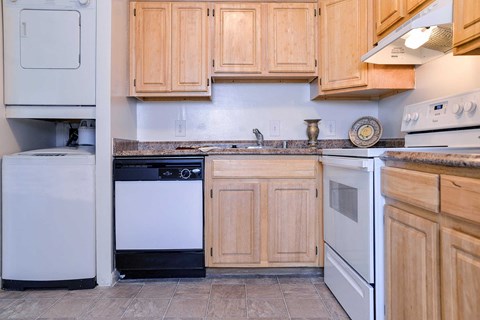 a kitchen with white appliances and wooden cabinets