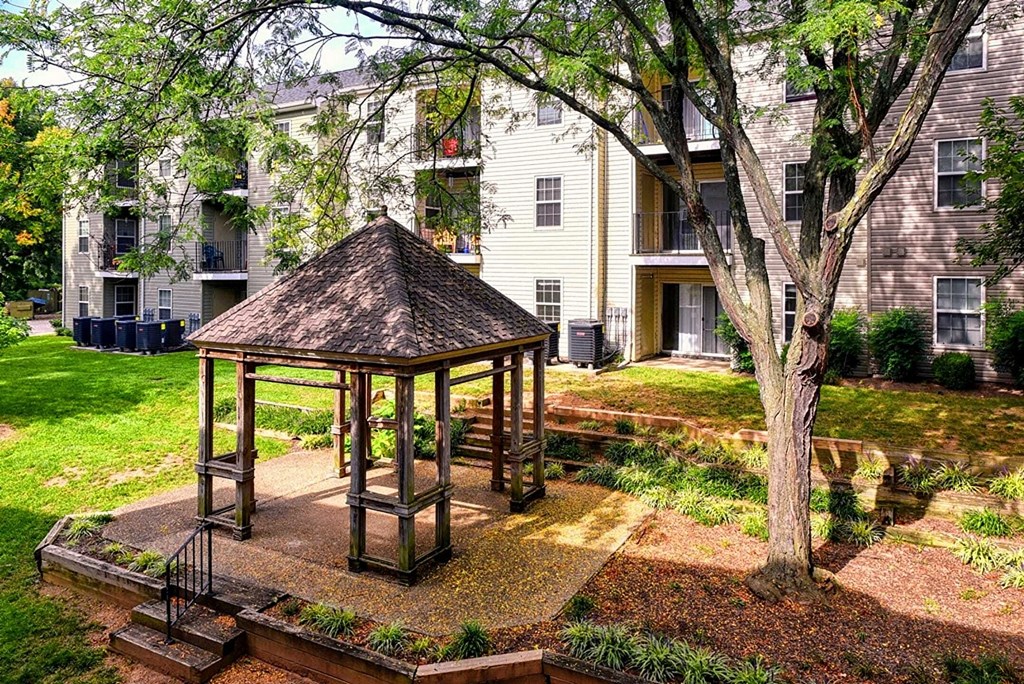 a gazebo in the front yard of an apartment building