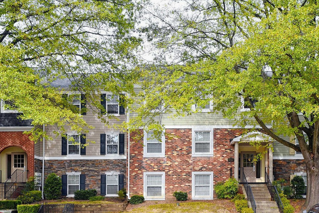 a brick house with a tree in front of it