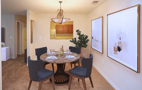 A dining room with a round table set for six.