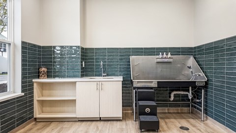 A kitchen with black chairs and a black refrigerator.