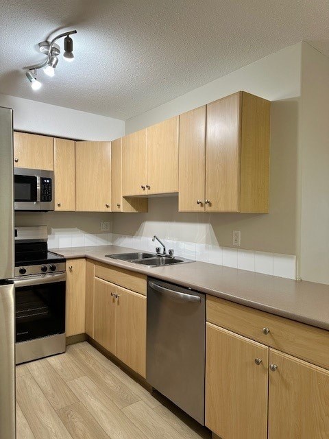 A kitchen with wooden cabinets and stainless steel appliances.