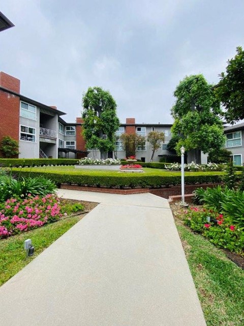 a walkway in front of an apartment building