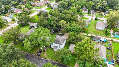 A bird's eye view of a residential area with houses and trees.