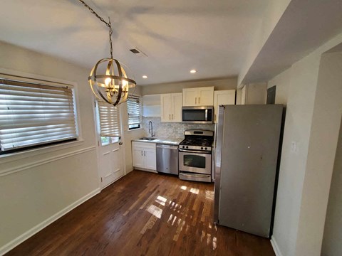 a kitchen with stainless steel appliances and white cabinets