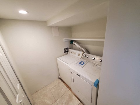 a laundry room with a washer and dryer in it