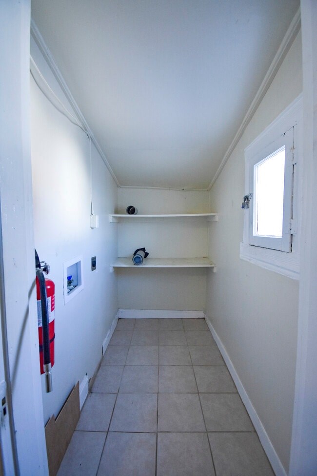 A hallway with a fire extinguisher on the wall.