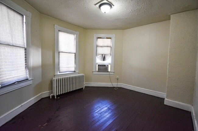 A room with a window and a radiator.