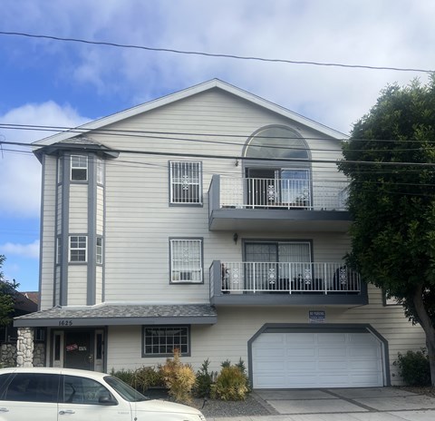 A two-story house with a balcony and a garage.