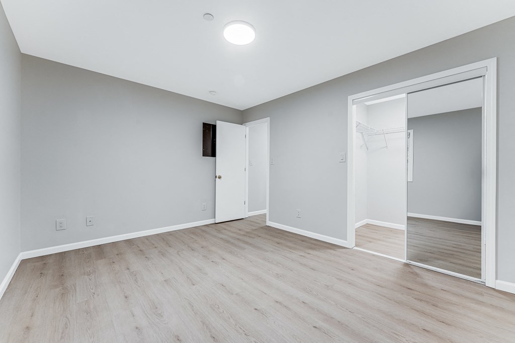 A room with a white door and a white wall.