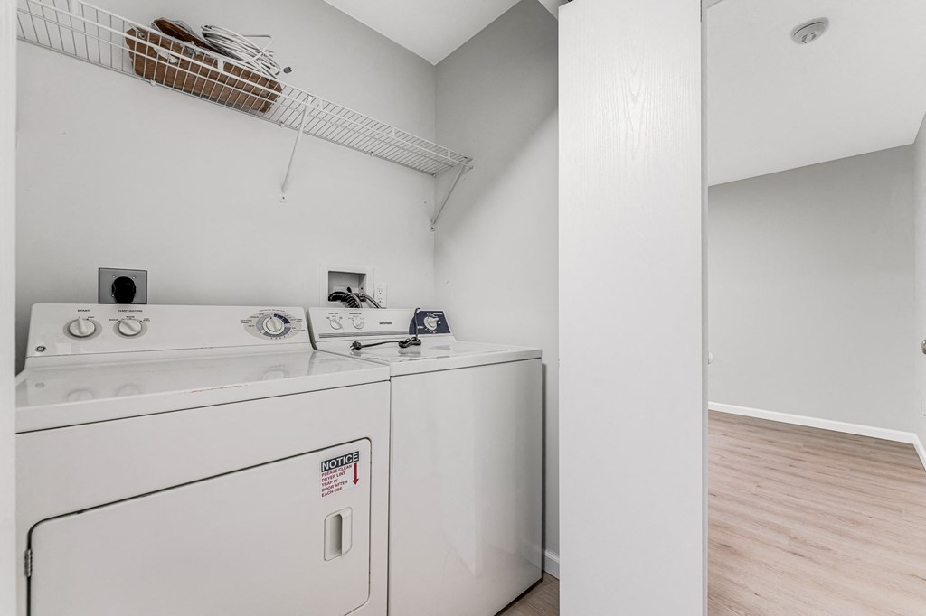 A white washing machine with a basket on top of it.