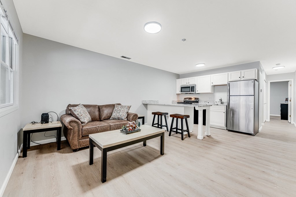 A modern living room with a brown couch and a wooden coffee table.