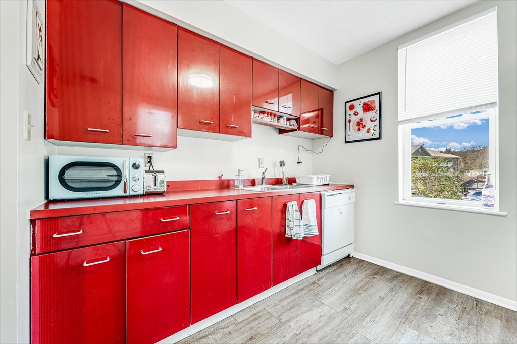 A kitchen with red cabinets.