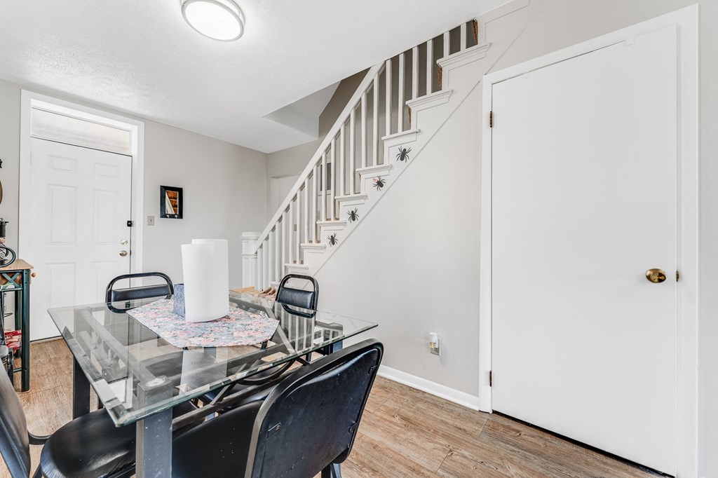 A dining room with a glass table and chairs.