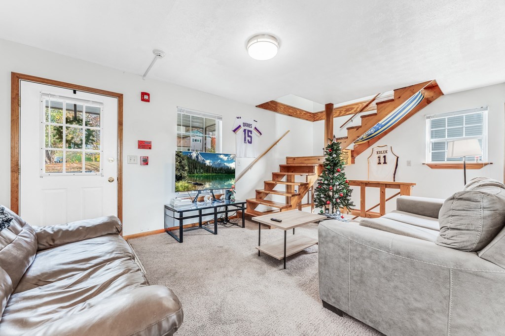 A living room with a grey couch and a coffee table.