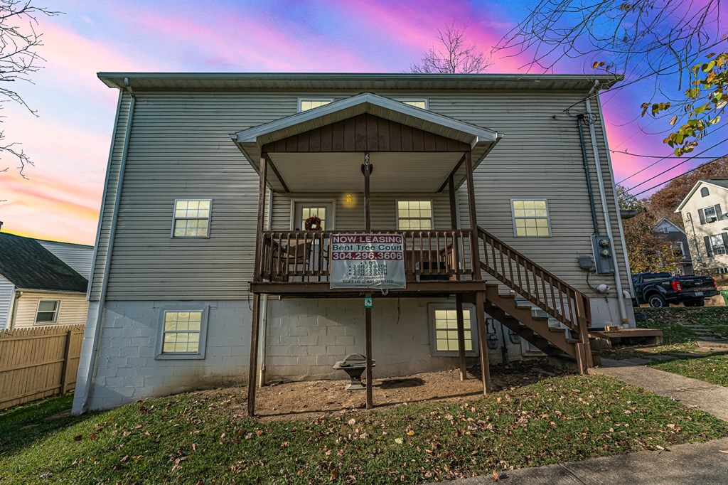 A house with a balcony and a sign.