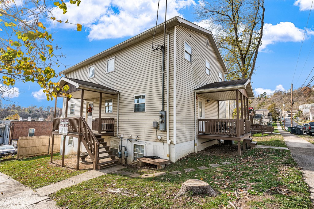A house with a beige siding and a brown deck.
