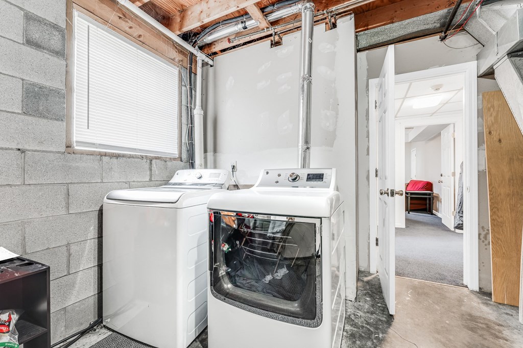 A white oven and dishwasher in a kitchen under construction.